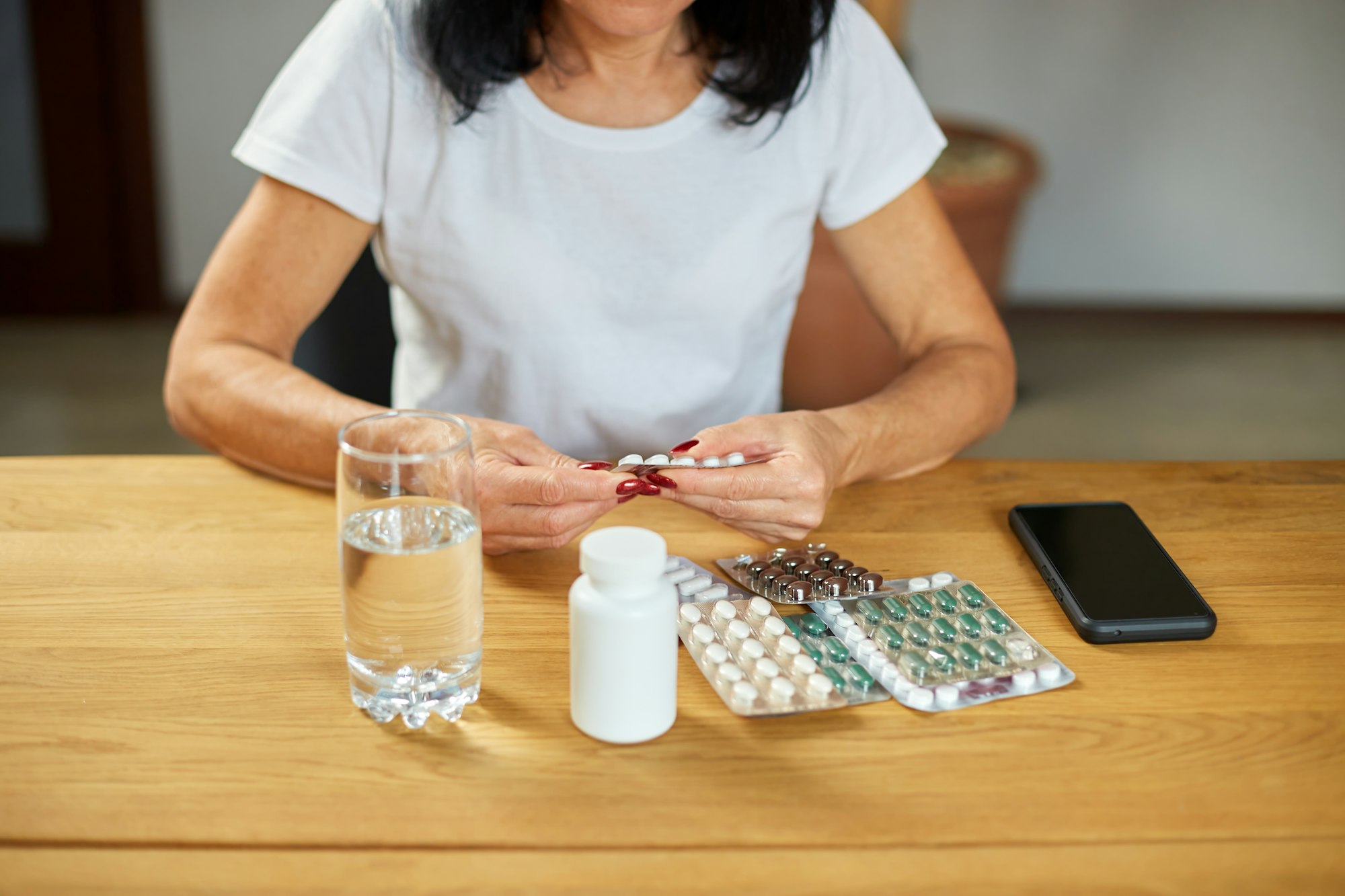 Senior woman take daily vitamins, beauty supplements